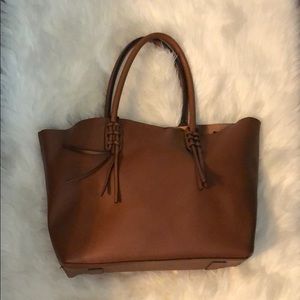 Tan large snap closure tote bag.